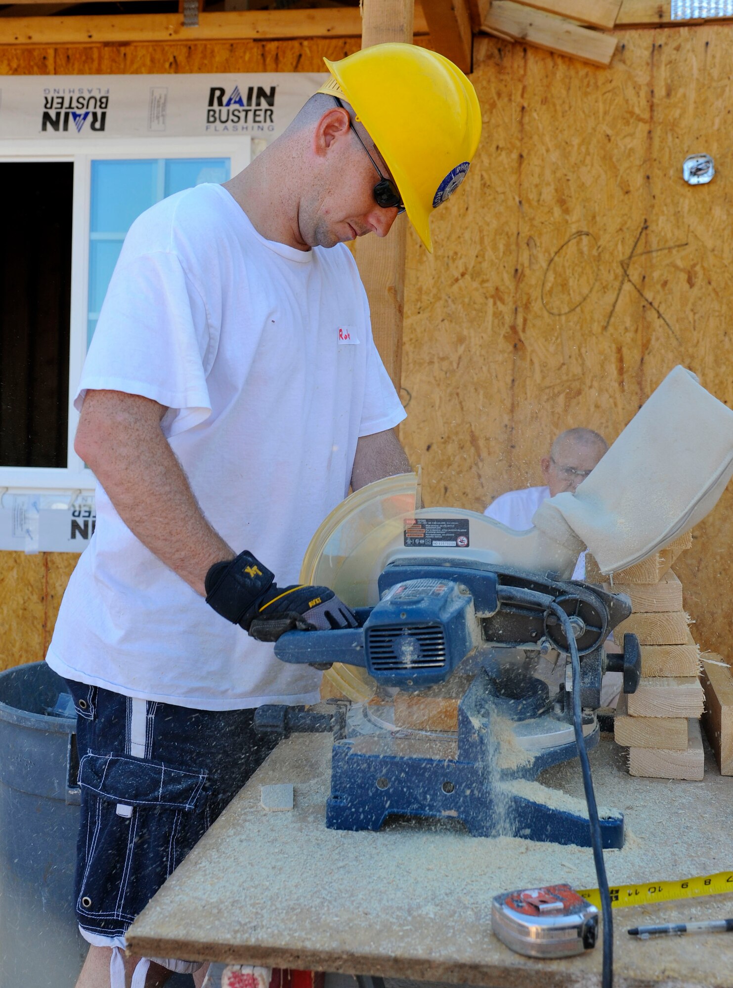 Staff Sgt. Robert Lloyd, 607th ACS tech control NCO-in-charge, cuts wood for a Habitat for Humanity project. The house is for a family of eight living in a three-bedroom apartment.  (U.S. Air Force photo by Staff Sgt. Darlene Seltmann)