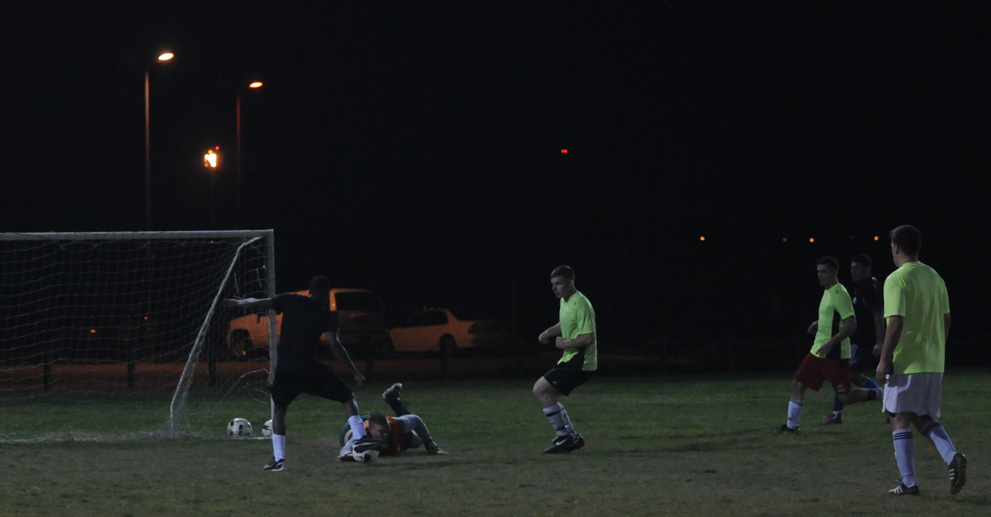 Airman 1st Class Brandon Evans, 100th Security Forces Squadron, taps the ball in for a goal during the second of two soccer matches Oct. 4, 2012, at RAF Mildenhall, England. The matches determined the winner of the Team Mildenhall Intramural Soccer championship and resulted in a clean sweep by the 100th SFS to claim the trophy. (U.S. Air Force photo by Tech. Sgt. Neal X. Joiner/Released)