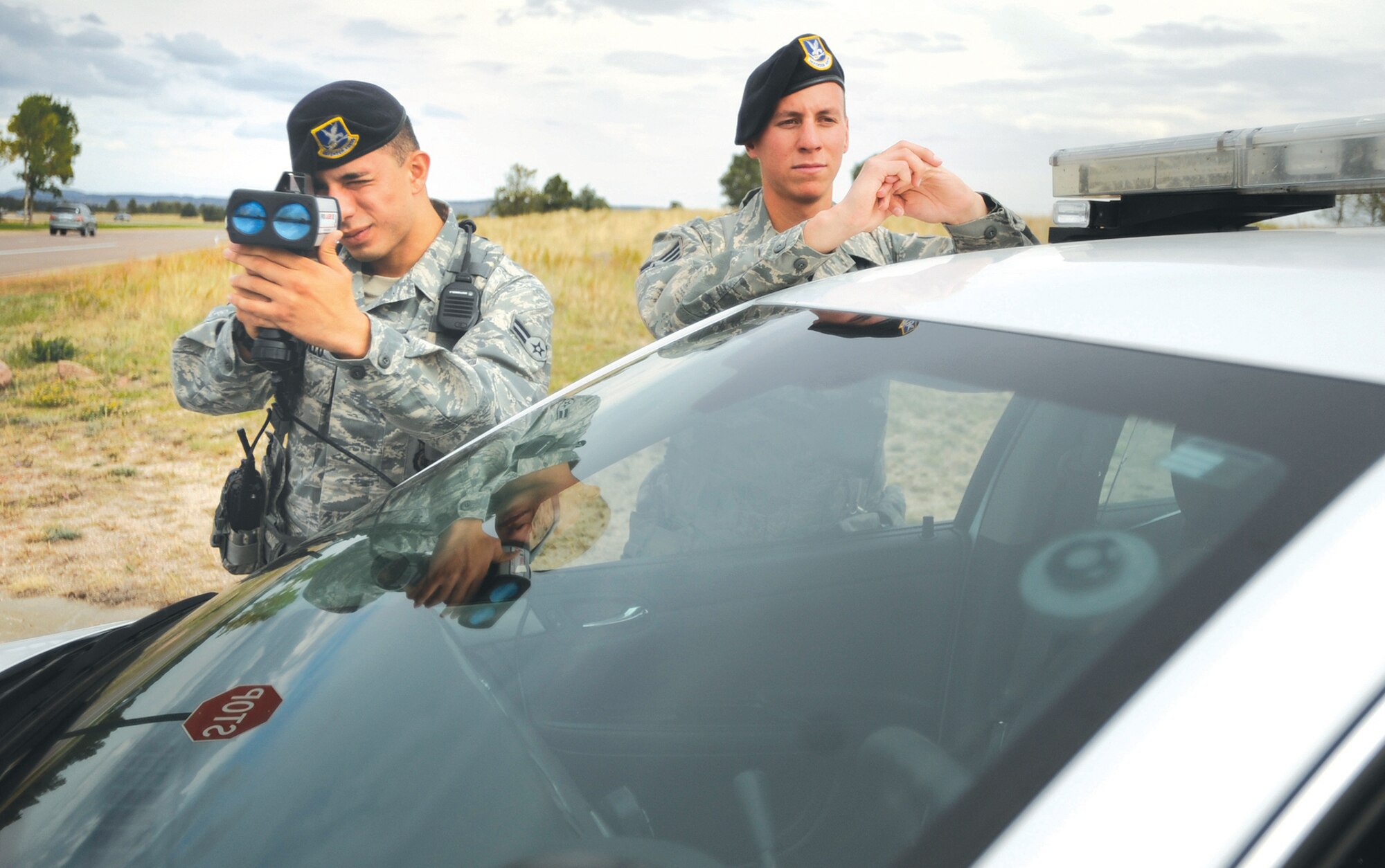 Airman 1st Class Hans Castillo and Senior Airman Brandon Aguirre, 10th Security Forces Squadron patrollers, use a radar gun to detect speeders on South Gate Boulevard Sept. 26. (U.S. Air Force photo/Carol Lawrence)