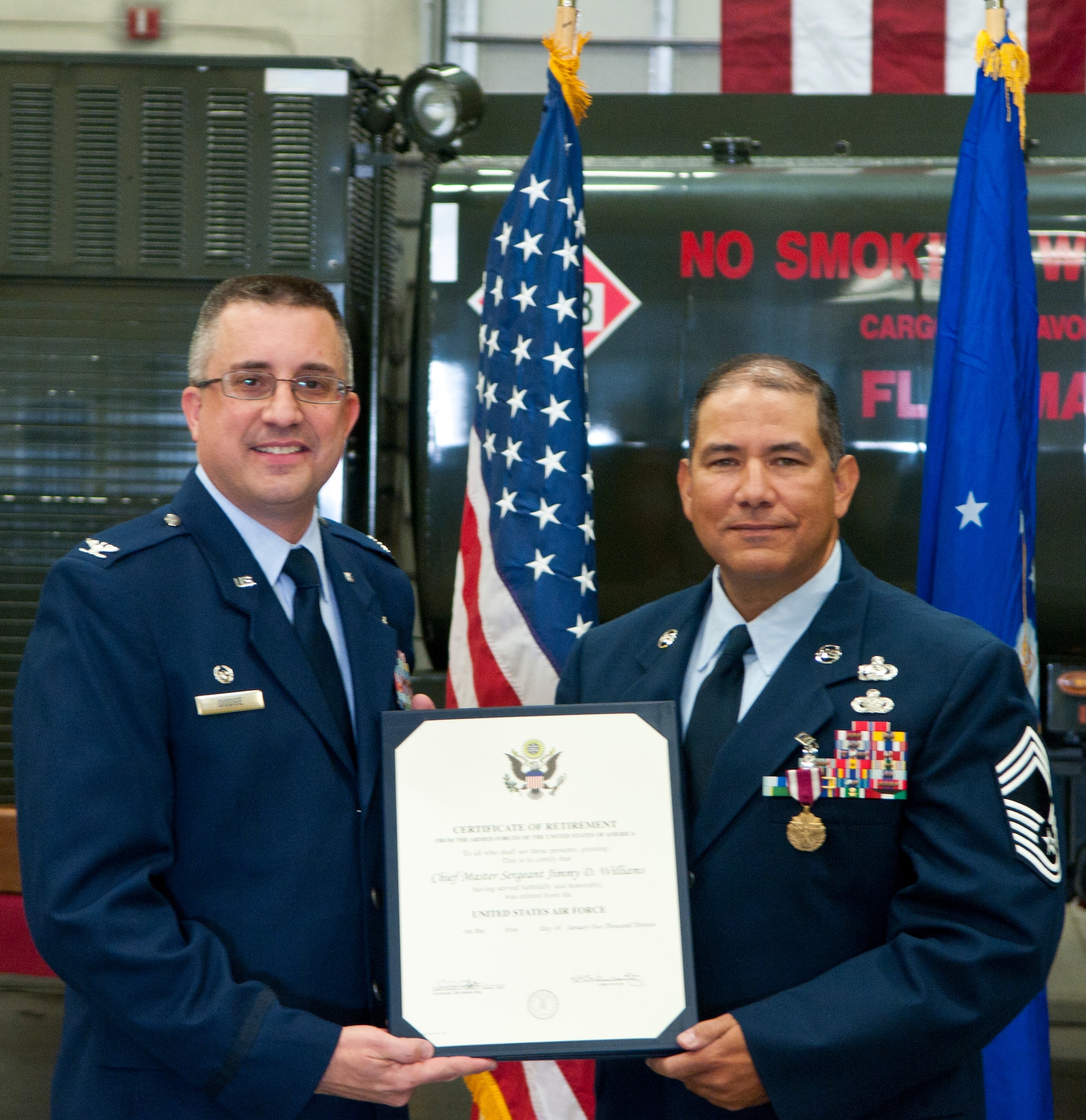 Col. Timothy Dodge, 90th Mission Support Group commander, presents Chief Master Sgt. Jimmy Williams, 90th MSG, a certificate of retirement from the U.S. Air Force in Bldg. 1270 Sept. 21. From 1983 until 2012, Williams served his country and retired from his final position as superintendent of the 90th MSG. (U.S. Air Force photo by Airman 1st Class Jason Wiese)