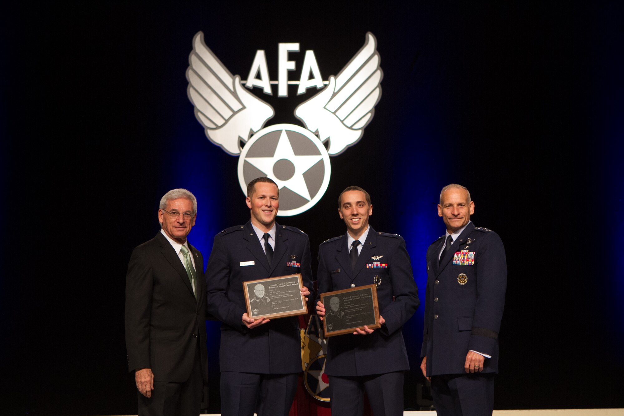 Mr. Sandy Schlitt, Air Force Association Chairman of the Board, and Lt. Gen. James Kowalski, commander of Air Force Global Strike Command, present Capt. Andrew Stevens and Capt. Ross Millard, 90th Operations Group, with the General Thomas S. Power Award Sept. 17 in Washington, D.C. The AFA recognized Stevens and Millard as “the best overall missile crew in the United States Air Force.” (U.S. Air Force photo by Staff Sgt. Torri Savarese)