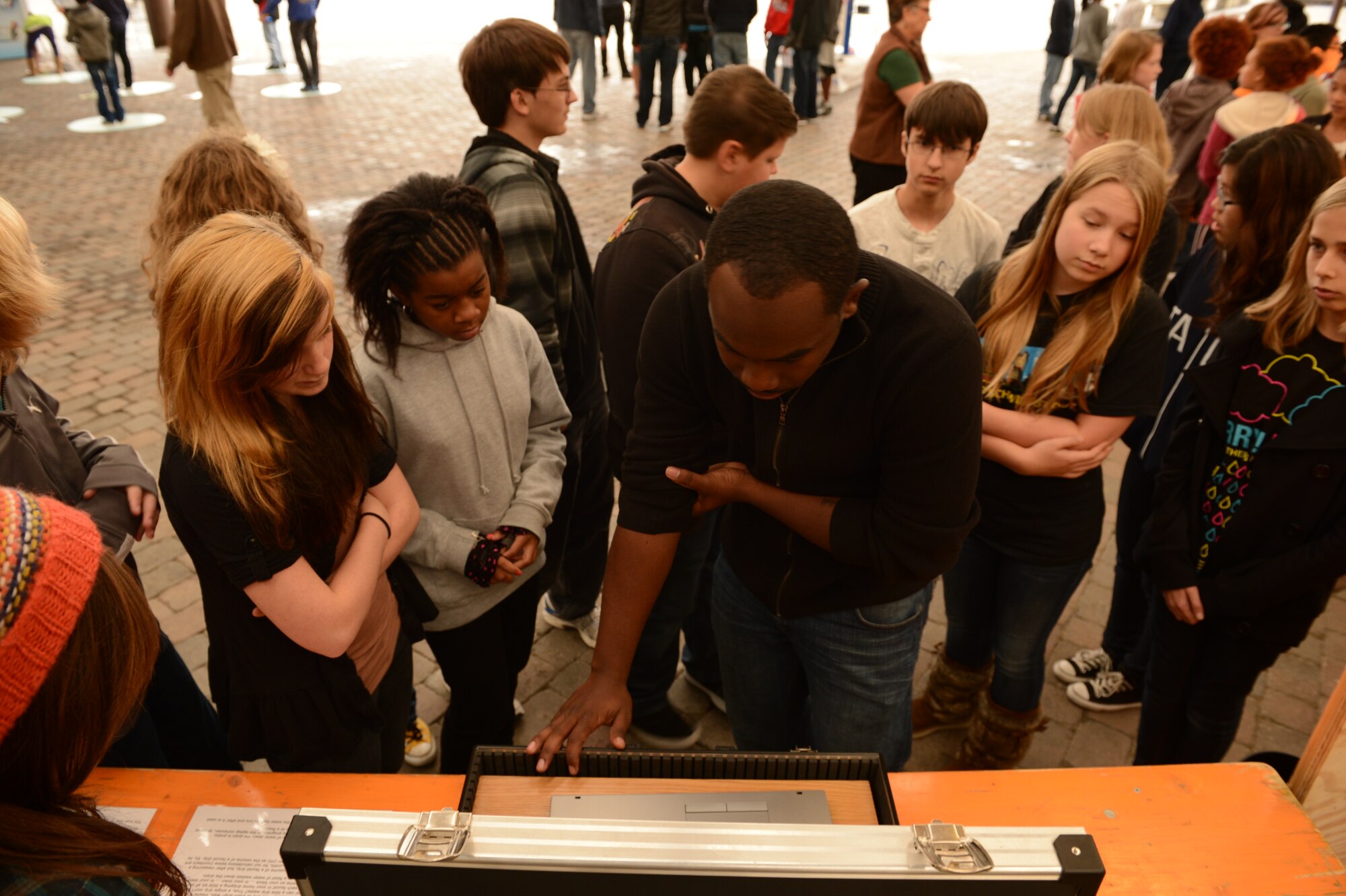 BITBURG ANNEX, Germany – Senior Airman Josiah Caldwell, 52nd Civil Engineer Squadron water and fuels maintenance technician and native of Chicago, explains how much water is wasted from a dripping faucet during Energy Day at Bitburg Middle School Oct. 4, 2012. Students learned about ways they can conserve energy around their homes. They learned about different types of light bulbs, water conservation, household appliances, and how they all contribute to energy waste. (U.S. Air Force photo by Staff Sgt. Nathanael Callon/Released)