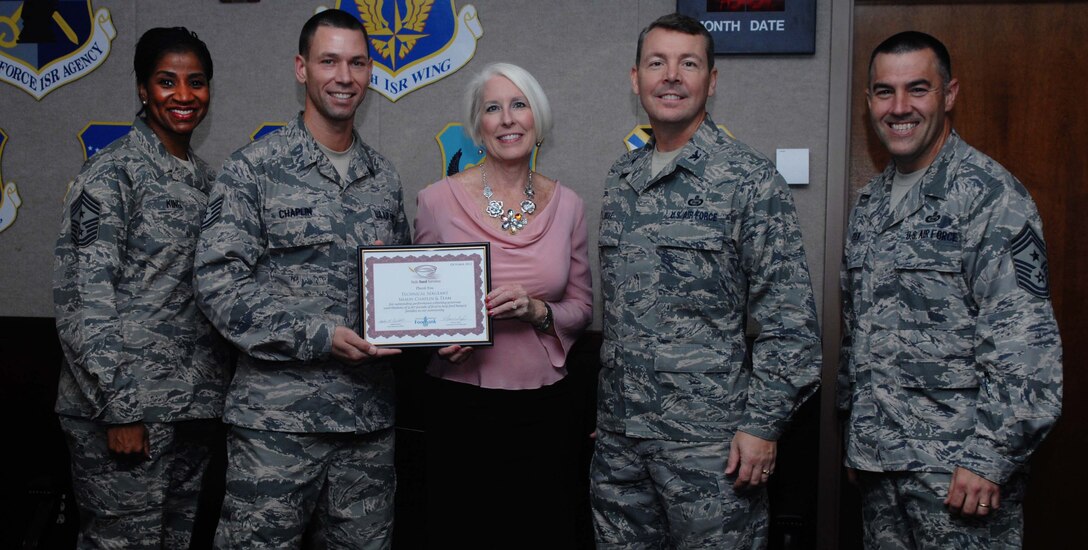 Tech. Sgt. Shaun Chaplin, second from left, 480th Intelligence, Surveillance and Reconnaissance Wing command chief executive, receives a certificate of gratification Oct. 2, 2012, for gathering 3,167 pounds of non-perishable food at Langley Air Force Base, Va. Chaplin gathered nearly 2,000 pounds more than last year’s food drive.