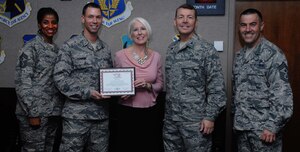 Tech. Sgt. Shaun Chaplin, second from left, 480th Intelligence, Surveillance and Reconnaissance Wing command chief executive, receives a certificate of gratification Oct. 2, 2012, for gathering 3,167 pounds of non-perishable food at Langley Air Force Base, Va. Chaplin gathered nearly 2,000 pounds more than last year’s food drive.