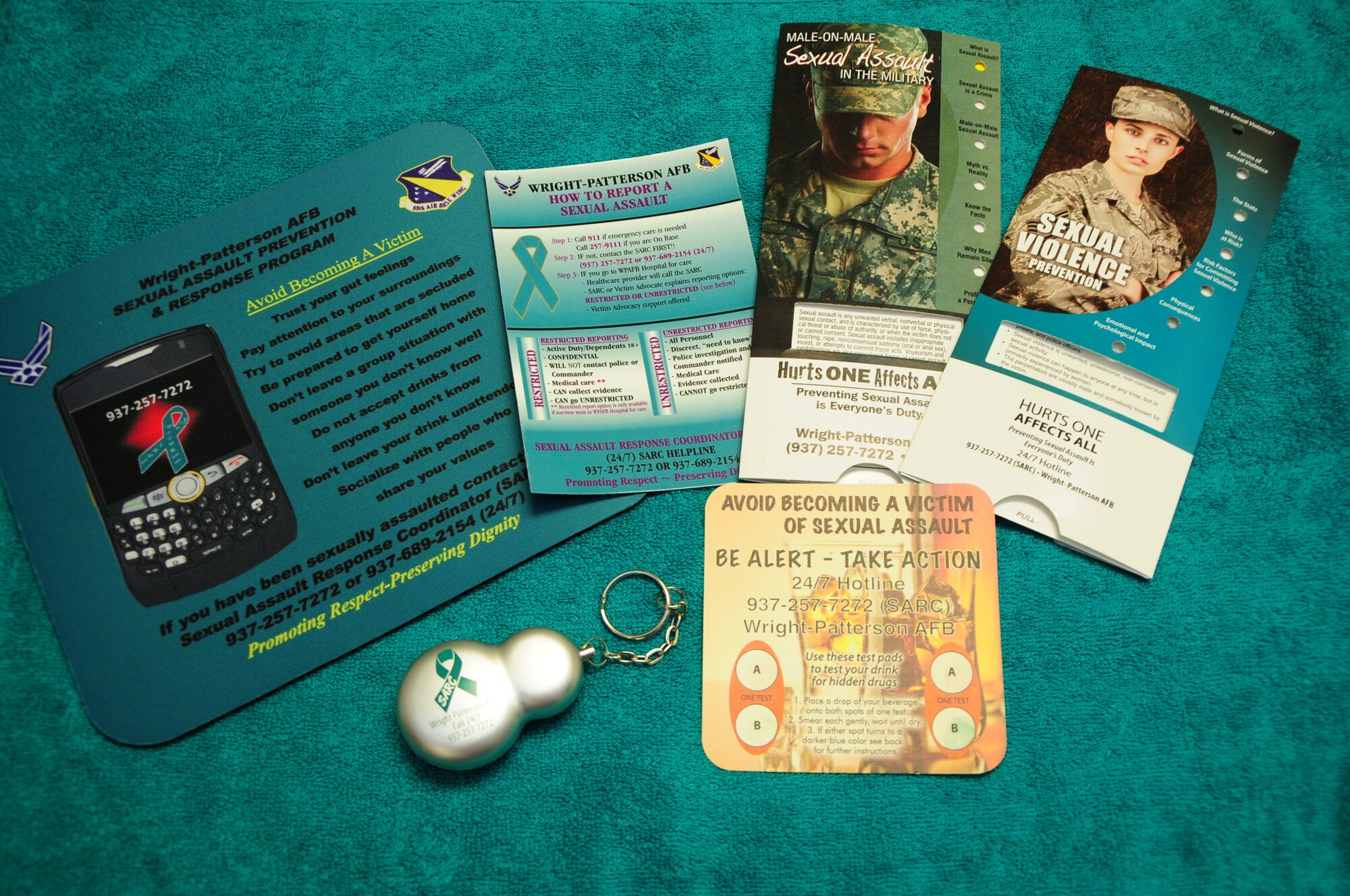 New SARC-branded giveaways range from magnets, mints and computer mousepads to posters and pamphlets targeting men and women. A key fob that can be pulled to trigger an ear-splitting alarm is an attention-getting deterrent; another intriguing giveaway tool is a drink coaster that tests drops of a beverage for the presence of such “date rape” drugs as GHB, Rohypnol and Ketamine.  (Skywrighter photo by Niki Jahns) 
  