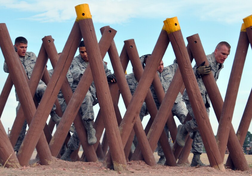 Tech. Sgt. Austin Wilson, 790th Missile Security Forces Squadron; Staff Sgt. Andrew Vautrin, 90th Security Forces Squadron; Senior Airman Oscar Gomez, 90th Security Forces Group Tactical Response Force; Senior Airman Jay Suttor, 790th MSFS; Airman 1st Class Colton Schoenegge, 90th SFG/TRF; and Airman 1st Class Mario Soriano, 90th SFG/TRF, weave their way through an obstacle during Air Force Global Strike Command’s Global Strike Challenge security forces competition Sept. 27 at Camp Guernsey, Wyo. (U.S. Air Force photo by Senior Airman Daniel Gage)