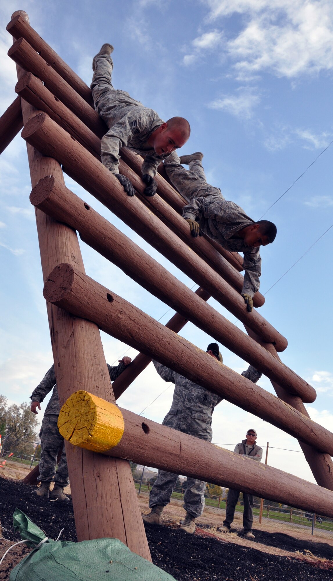 Senior Airman Jay Suttor, 790th Missile Security Forces Squadron, and Airman 1st Class Mario Soriano, 90th Security Forces Group Tactical Response Force, descend head first down the inverted ladder during Air Force Global Strike Command’s Global Strike Challenge security forces competition Sept. 27 at Camp Guernsey, Wyo. (U.S. Air Force photo by Senior Airman Daniel Gage)