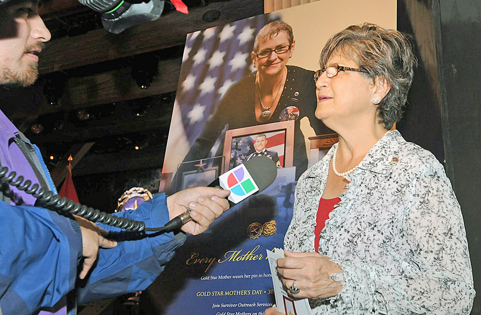 Mary Laureana Aguirre Garza, Gold Star Mother of Army Cpl. Nathaniel Aguirre, shares
her story with a reporter about her son and her ordeal following his death in combat in
Oct. 22, 2006. Garza was present for the Survivor Outreach Services ribbon cutting
ceremony Sept. 29 at the Joint Base San Antonio-Fort Sam Houston Theater. (U.S. Army photo by Sgt. 1st Class Christopher DeHart)