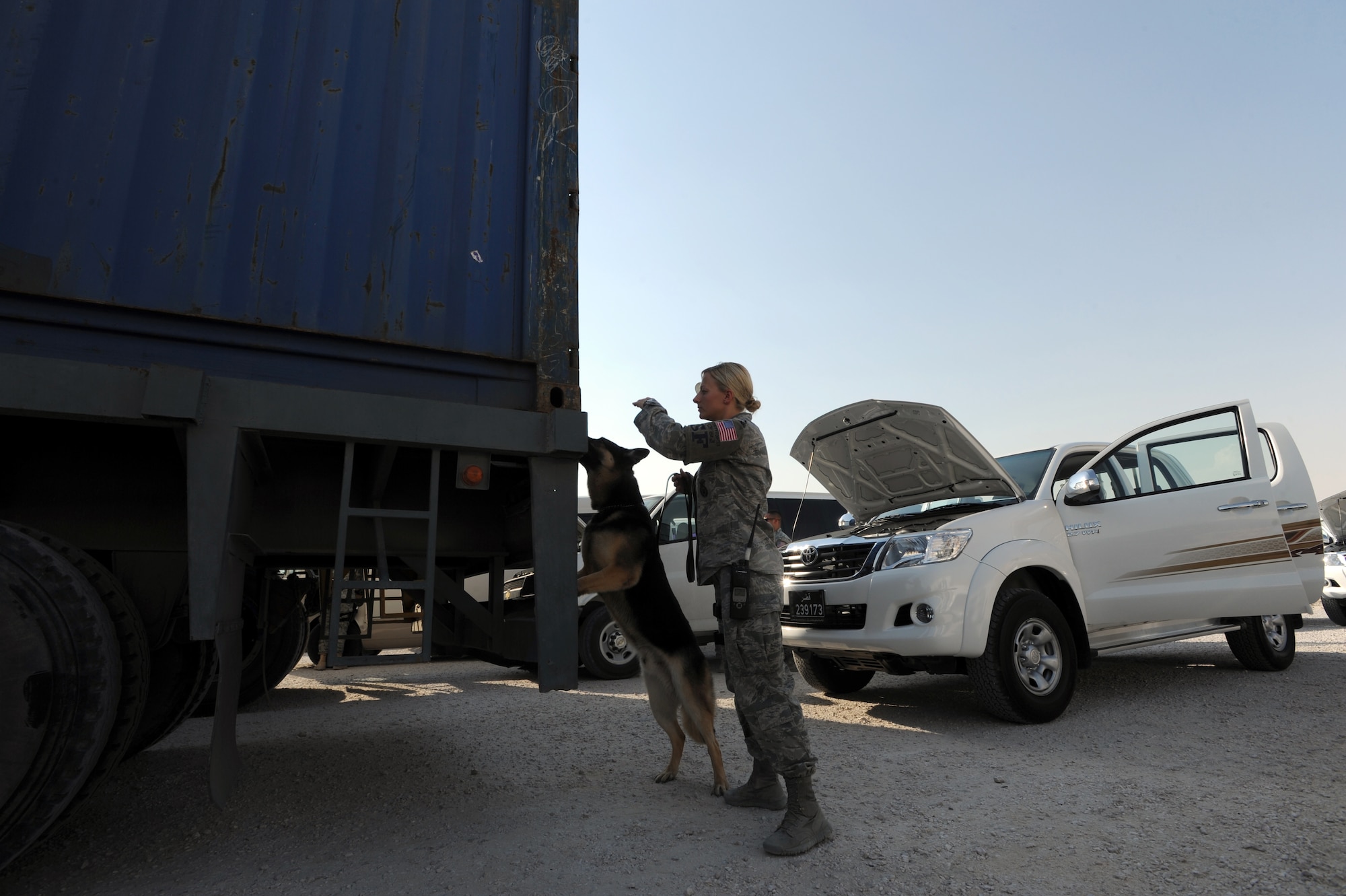U.S. Air Force Staff Sgt. Bobbie Ohm and military working dog Nero, search a vehicle for prohibited items at the 379th Air Expeditionary Wing, Southwest Asia, October 1, 2012. The canine?s heightened sense of smell makes it a valuable asset in detecting and preventing prohibited items from being brought on the base. (U.S. Air Force photo/Staff Sgt. Sheila deVera) 