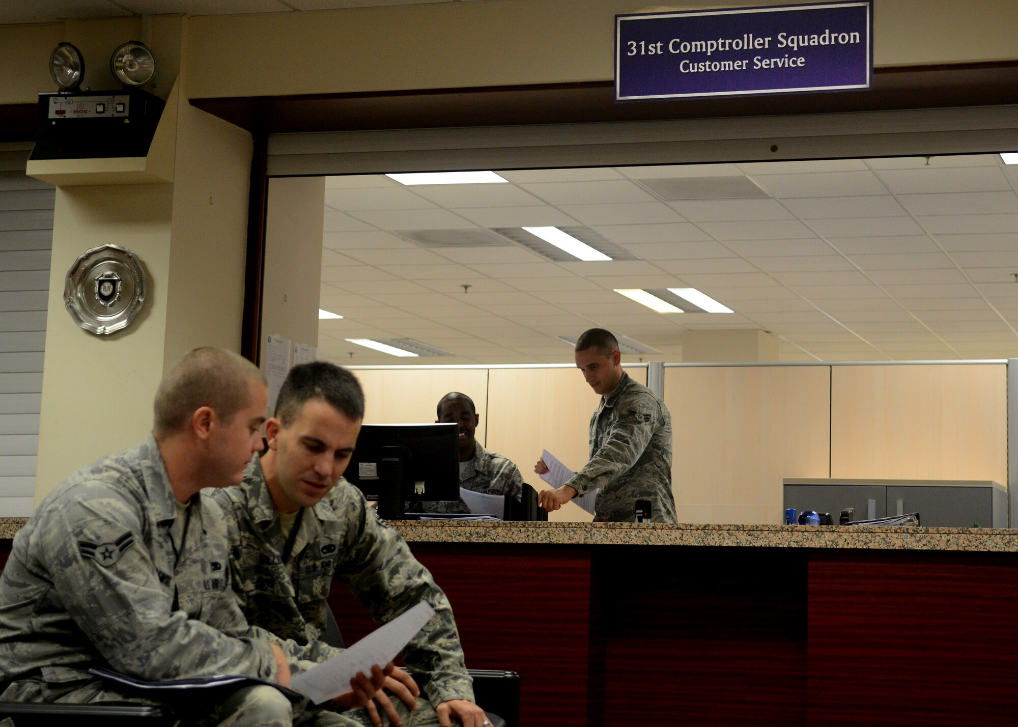 Airmen wait to receive assistance from members of the 31st Comptroller Squadron Oct. 2 at Aviano Air Base, Italy. Members of the 31st CPTS also provide financial analysis services to more than 5,000 personnel stationed here. (U.S. Air Force photo/Airman 1st Class Jenay Randolph)