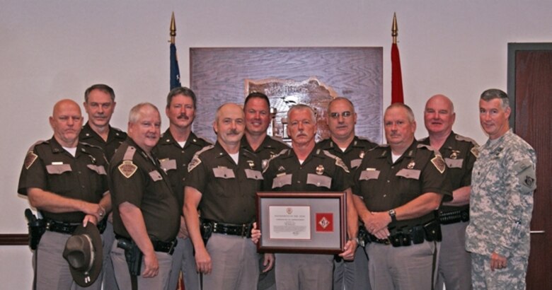Oklahoma Highway Patrol Marine Enforcement Section Trooper Tony Richardson, center, his fellow troopers, and Tulsa District U.S. Army Corps of Engineers Commander Col. Michael Teague, far right, after Teague presented the Commander’s Certificate of Appreciation to Richardson. The award, given for outstanding public service, was in recognition of Richardson’s accomplishments in boating and water safety education.