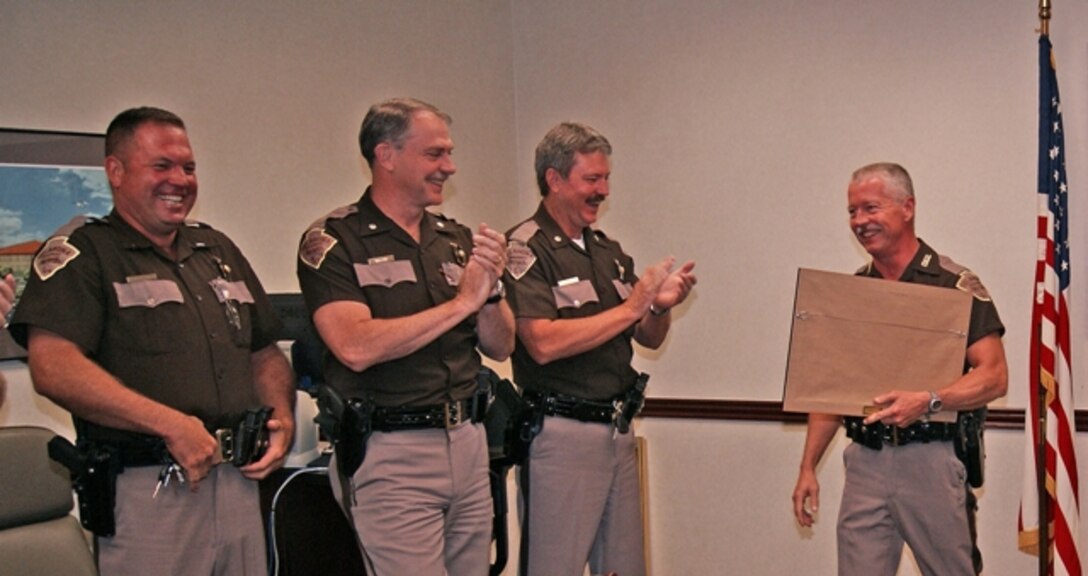 Oklahoma Highway Patrol Troopers share a laugh with Trooper Tony Richardson after he received the Commander’s Certificate of Appreciation from Tulsa District U.S. Army Corps of Engineers Commander Col. Michael Teague. The ceremony was kept secret from Richardson, who arrived for the ceremony thinking he was attending a routine meeting. His colleagues were amused at Richardson’s shocked reaction when he realized the gathering was to honor him.