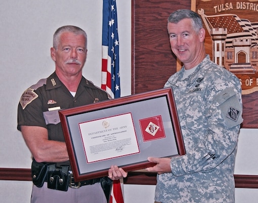 The Commander’s Certificate of Appreciation is presented to Oklahoma Highway Patrol Marine Enforcement Section Trooper Tony Richardson by Tulsa District U.S. Army Corps of Engineers Commander Col. Michael Teague. The award recognizes Richardson’s outstanding public service in the area of boating and water safety education. Richardson routinely works directly with Corps staff in organizing media campaigns and serving as a spokesperson for media interviews about boating and water safety.