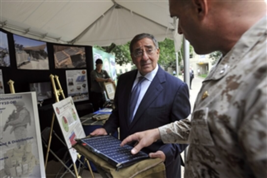 Secretary of Defense Leon E. Panetta holds slate of solar cells as he listens to a Marine officer describe the energy efficiency efforts of the U.S. Marine Corps at the Pentagon's Energy Security Event on Oct. 4, 2012. 