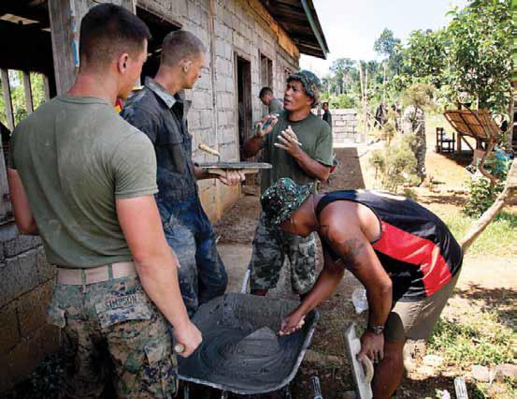 Philippine Marine Staff Sgt. R. B. Barsenas, middle, instructs U.S. Marine combat engineers
on building materials during renovations at Ranzang National High School, Palawan, Republic
of the Philippines, Oct. 22, 2011. U.S. and Philippine Marines installed a new ceiling, gutters,doors, windows and a water-catching tank to the school during Amphibious Landing Exercise2012. Similar projects will be conducted as part of PHIBLEX 13 from Oct. 8 18. Barsenas is part of Marine Battalion Landing Team 12, Naval Forces West, armed forces of the Philippines. The U.S. Marine combat engineers are assigned to Combat Logistics Battalion 31, 31st Marine Expeditionary Unit, III Marine Expeditionary Force.