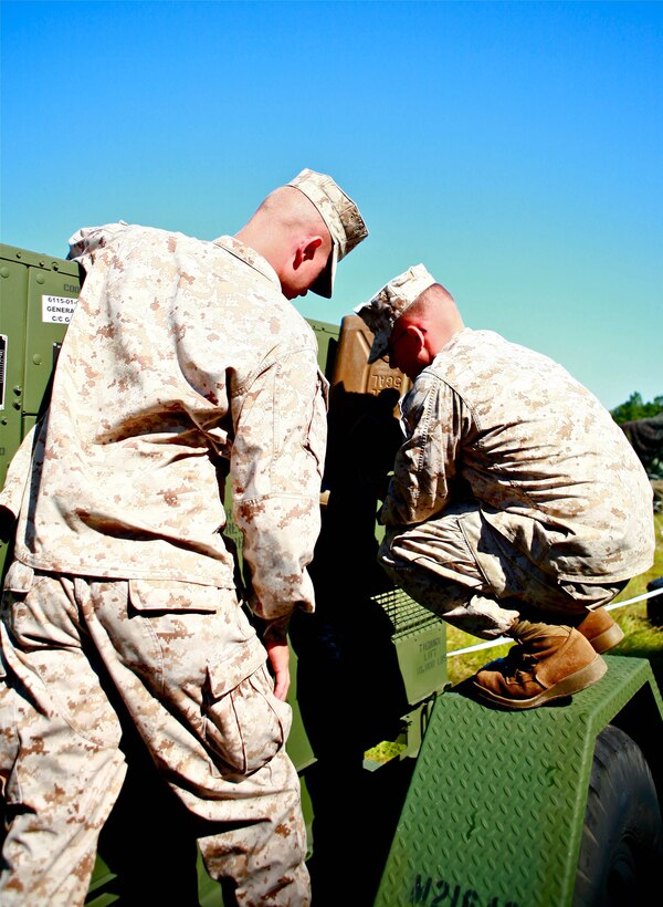 Lance Cpl. Jeremy P. Krul (left), an electrician and Lance Cpl. Jared M. Cole, a generator Mechanic both with Alpha Company, 8th Communications Battalion, II Marine Expeditionary Force Headquarters Group, put fuel into a generator used to power equipment during a field exercise aboard Marine Corps Base Camp Lejeune, Sept. 25. The Marines needed an ample amount of power in order to properly send and receive data from a satellite and establish phone lines and internet.