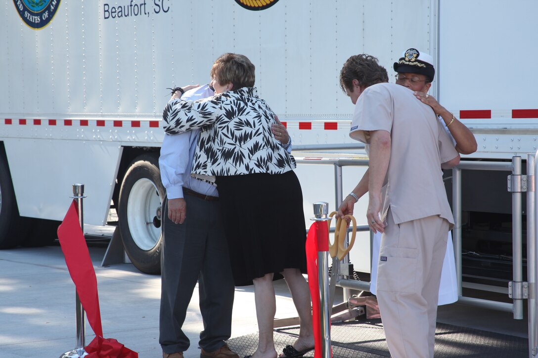 Ralph H. Johnson VA Medical Center radiology administrator Stafford Stinson, Director of Ralph H. Johnson VA Medical Center Carolyn Adams, commanding officer of Naval Hospital Beaufort Capt. Joan Queen, and Naval Hospital Beaufort's retired Navy Chief David Estep embrace after cutting the ribbon at the grand opening of the new mobile MRI at Naval Hospital Beaufort.