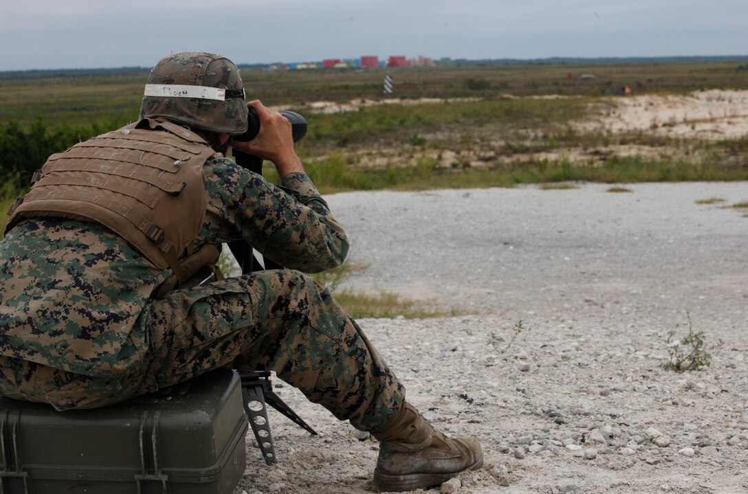 Sgt. Cory C. Ploch, an instructor with Infantry Training Battalion, School of Infantry – East, uses optics to look down range aboard Marine Corps Base Camp Lejeune as a forward observer as part of an instructor-only class on firing from the defilade Sept 19. The class is taught the rare technique of firing from the defilade with a direct-fire M240B machine gun. 