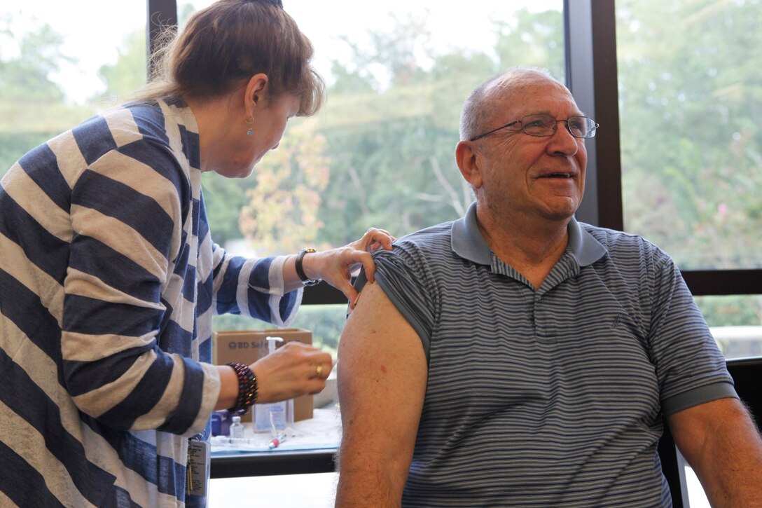 Patrick E. Libby, a retired Master Sgt. receives a flu shot during the quarterly retiree town hall meeting held at the Naval Hospital aboard Marine Corps Base Camp Lejeune Sept. 24.  The town hall meetings help get retirees together to discuss upcoming events, educate them on possible health risks and answer questions from medical personnel.