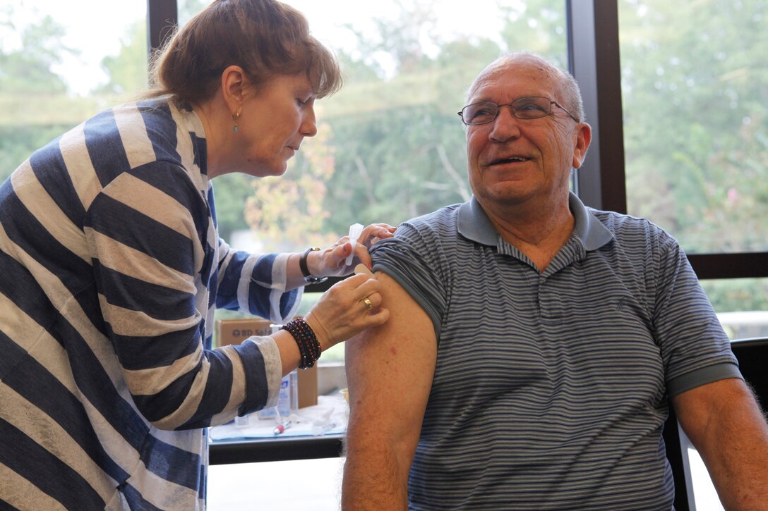 Patrick E. Libby, a retired Master Sgt. receives a flu shot during the quarterly retiree town hall meeting held at the Naval Hospital aboard Marine Corps Base Camp Lejeune Sept. 24.  The town hall meetings help get retirees together to discuss upcoming events, educate them on possible health risks and answer questions from medical personnel.