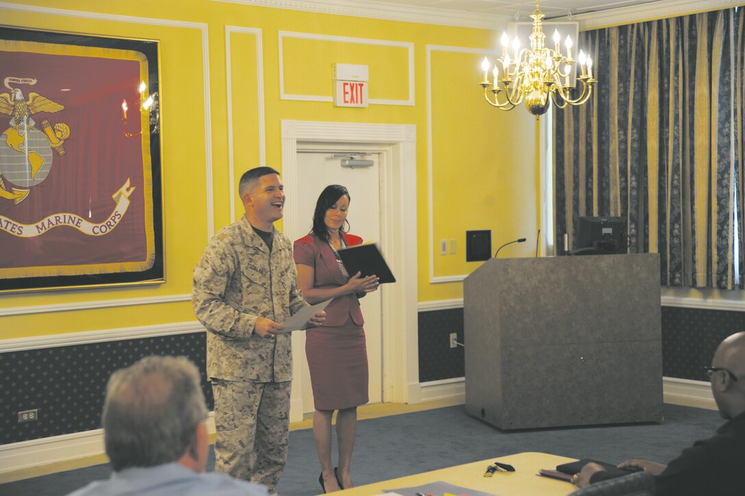 Col. Yori R. Escalante, chief of staff, and Staff Sgt. Juana L. DeLosSantos, equal opportunity advisor, both with Marine Corps Logistics Command, present certificates to class members at the Senior Leaders Workshop at the base Conference Center, Sept 26.
