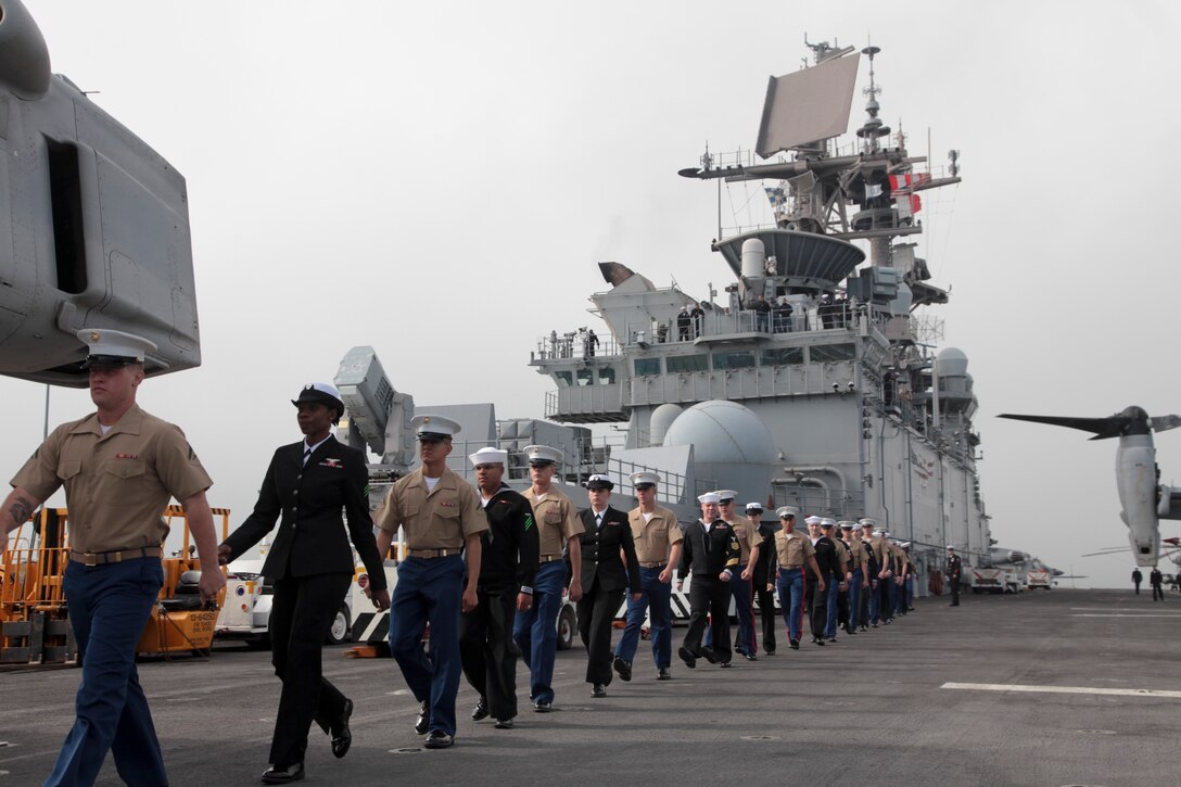 20121003-M-IO267-144

SAN FRANCISCO - U.S. Marines and Sailors with the 13th Marine Expeditionary Unit march atop the flight deck of the USS Makin Island (LHD-8) prior to arriving in San Francisco for the 2012 Fleet Week, Oct 3, 2012. From Oct. 3-8, Marines and Sailors of the 13th MEU, I Marine Expeditionary Brigade, will participate in numerous community outreach events including the Italian Heritage Day parade, urban search and rescue demonstration, park restoration projects and hospital visits. 
 (U.S. Marine Corps photo by Lance Cpl. David Gonzalez/Released)
