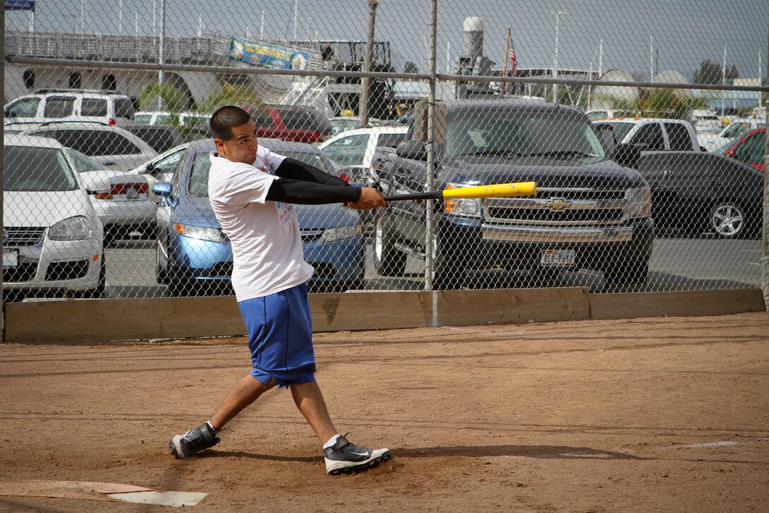 Salvador Martinez, the lead-off batter of the Navy Recruiting District San Francisco team, slugs a ball during the San Francisco Fleet Week Interagency Softball Competition Oct. 4. The Navy team beat the TRX team, derived from the suspension training creators who’s workout bands systems are currently used by the Marine Corps and professional athletes worldwide, in the first round of the tournament-style competition. The Coast Guard San Francisco Sector team then beat the Navy team in the last round of the day’s tournament. Martinez is a Del Rio, Texas, native.