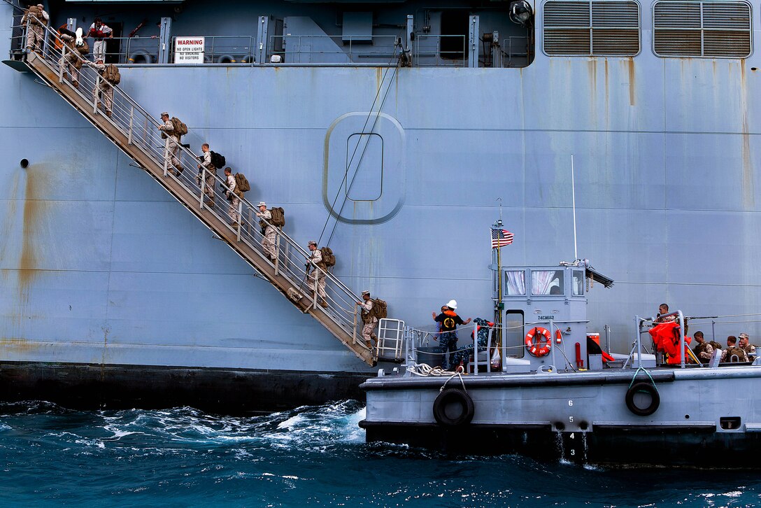 DIEGO GARCIA - Marines with Company A, 1st Battalion, 4th Marine Regiment, 1st Marine Division board the USNS Lewis and Clark (T-AKE-1) here Sept. 30 while in transit to the Maldives for Exercise Coconut Grove 2012, scheduled Oct. 6-16. Coconut Grove is a bilateral training exercise conducted bi-annually between the U.S. Marine Corps and the Maldivian National Defense Force.