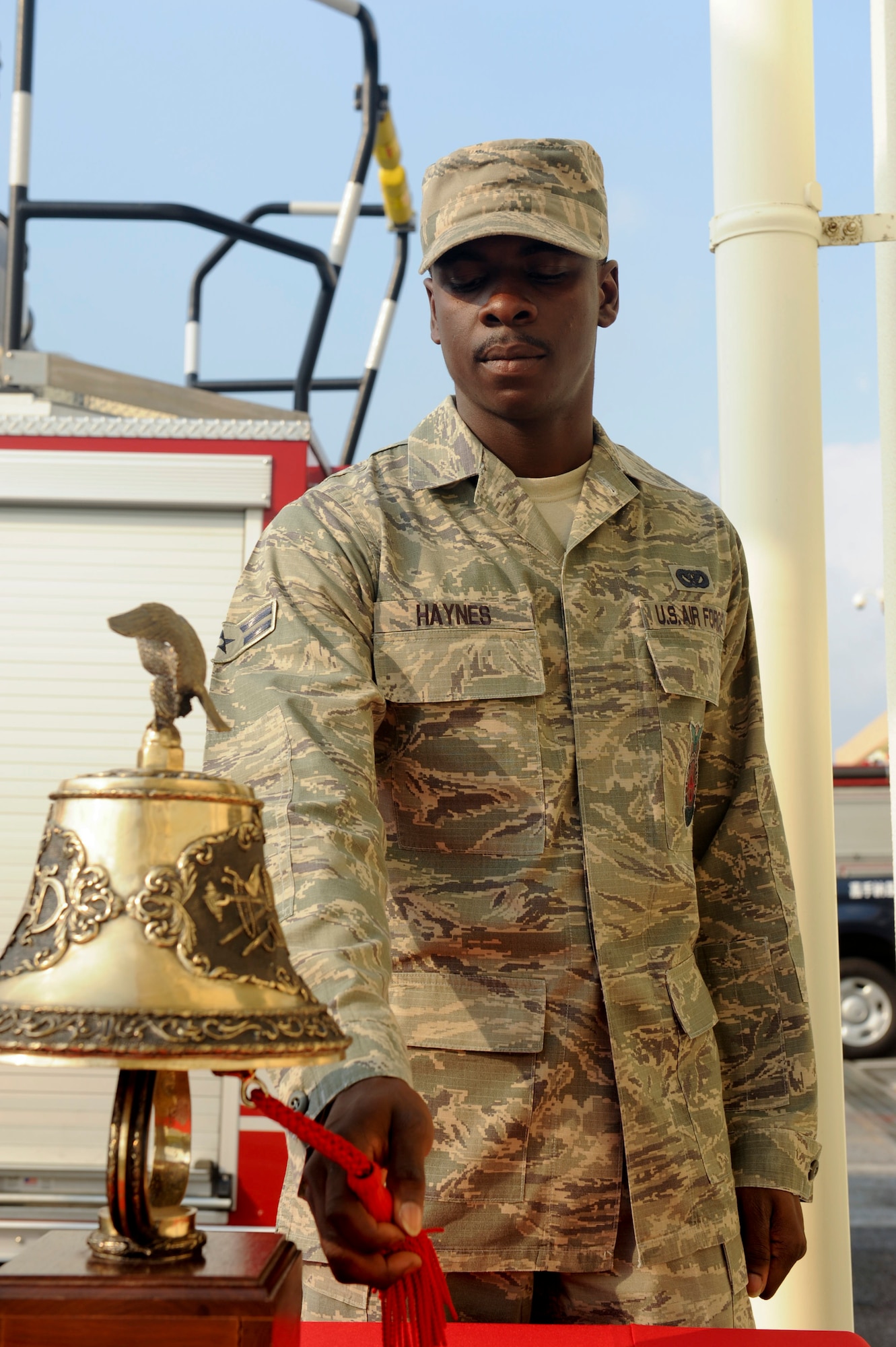 U.S. Air Force Airman 1st Class Allen Haynes, Kadena Fire Emergency Services firefighter, rings a bell nine times during the Bells Across America Fallen Firefighters ceremony on Kadena Air Base, Japan, Oct. 7, 2012. Departments sound a series of bells when a firefighter has died in the line of duty to alert members that a comrade has made the ultimate sacrifice. The bell was rung three times for each fallen firefighter Kadena has lost. (U.S. Air Force photo/Airman 1st Class Hailey R. Davis)