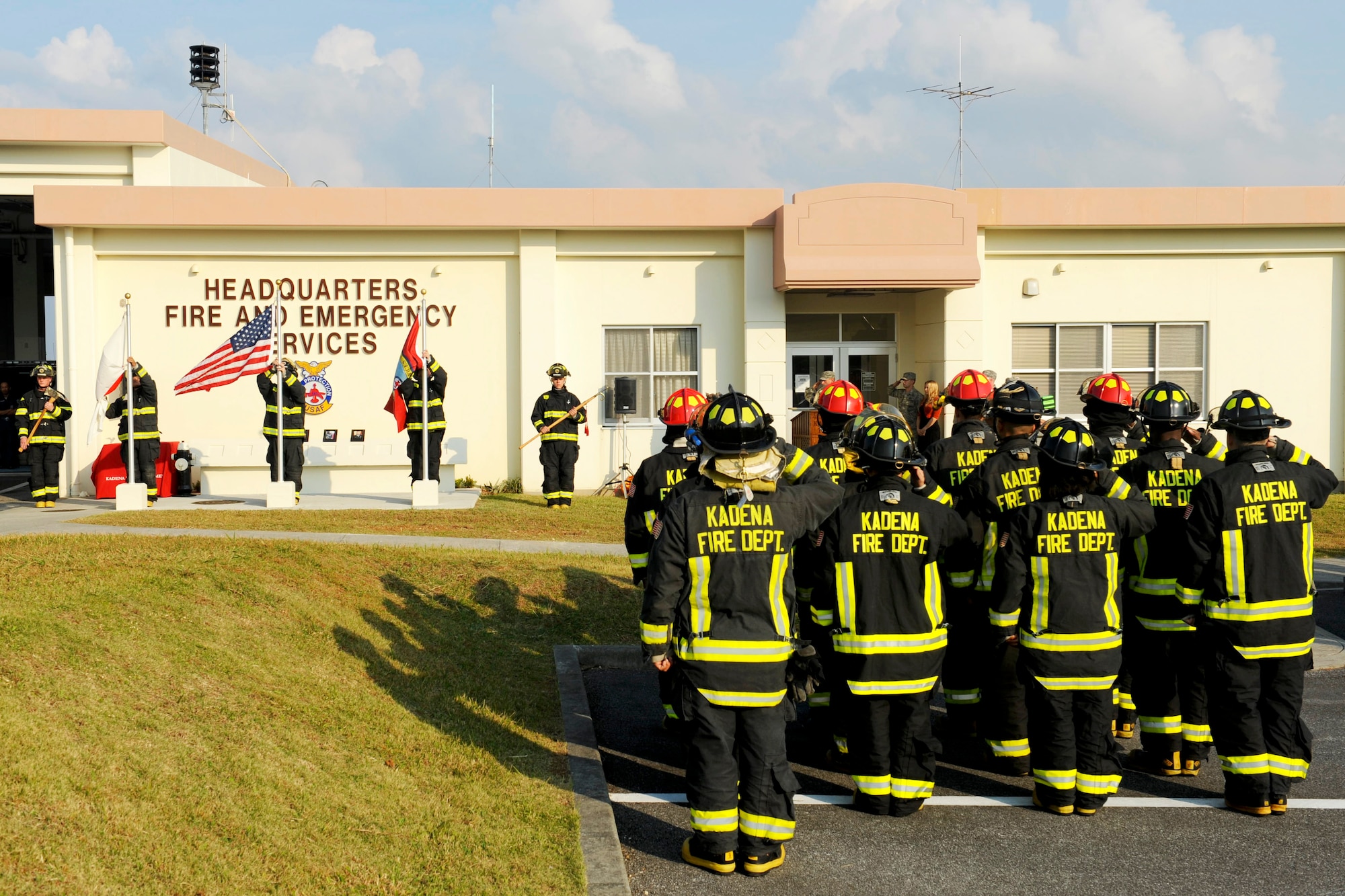The Kadena Fire Emergency Services Honor Guard presents the colors as a formation of firefighters salutes during the Bells Across America Fallen Firefighters ceremony on Kadena Air Base, Japan, Oct. 7, 2012. Bells Across America began in 2011 as a joint venture between fire departments and their respective houses of worship to honor firefighters who paid the ultimate sacrifice in 2010. Kadena and Misawa Air Bases are participating in the ceremony to honor fallen firefighters who paid the ultimate sacrifice in 2011. (U.S. Air Force photo/Airman 1st Class Hailey R. Davis)