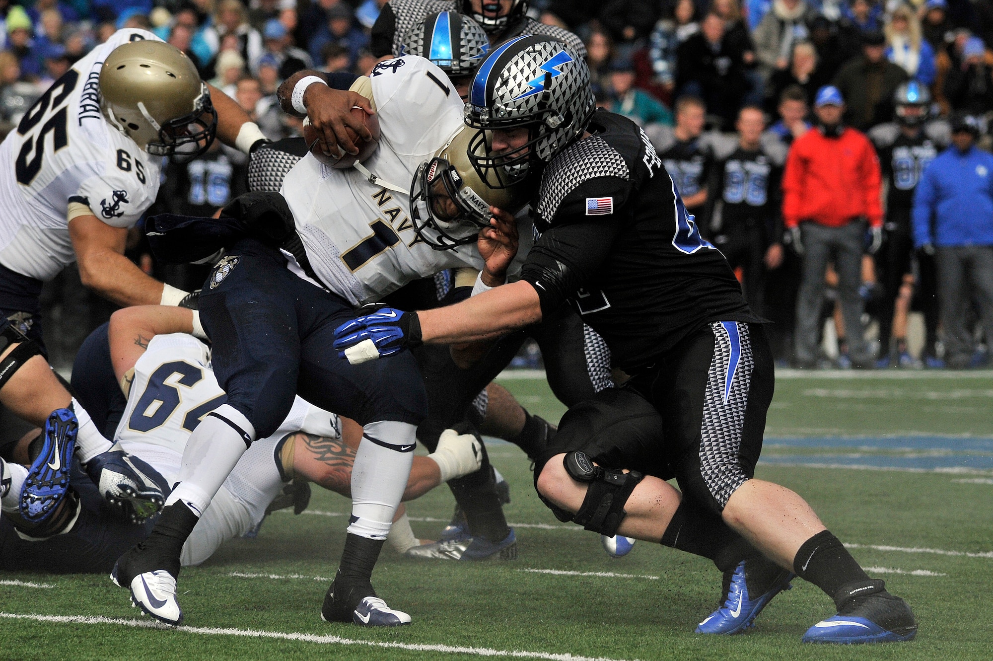 Air Force senior linebacker Austin Niklas stops Navy quarterback Trey Miller during the Navy-Air Force game at Falcon Stadium Oct. 6, 2012. The Midshipmen defeated the Falcons in overtime, 28-21. (U.S. Air Force photo/Mark Watkins)
