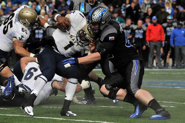 Air Force senior linebacker Austin Niklas stops Navy quarterback Trey Miller during the Navy-Air Force game at Falcon Stadium Oct. 6, 2012. The Midshipmen defeated the Falcons in overtime, 28-21. (U.S. Air Force photo/Mark Watkins)
