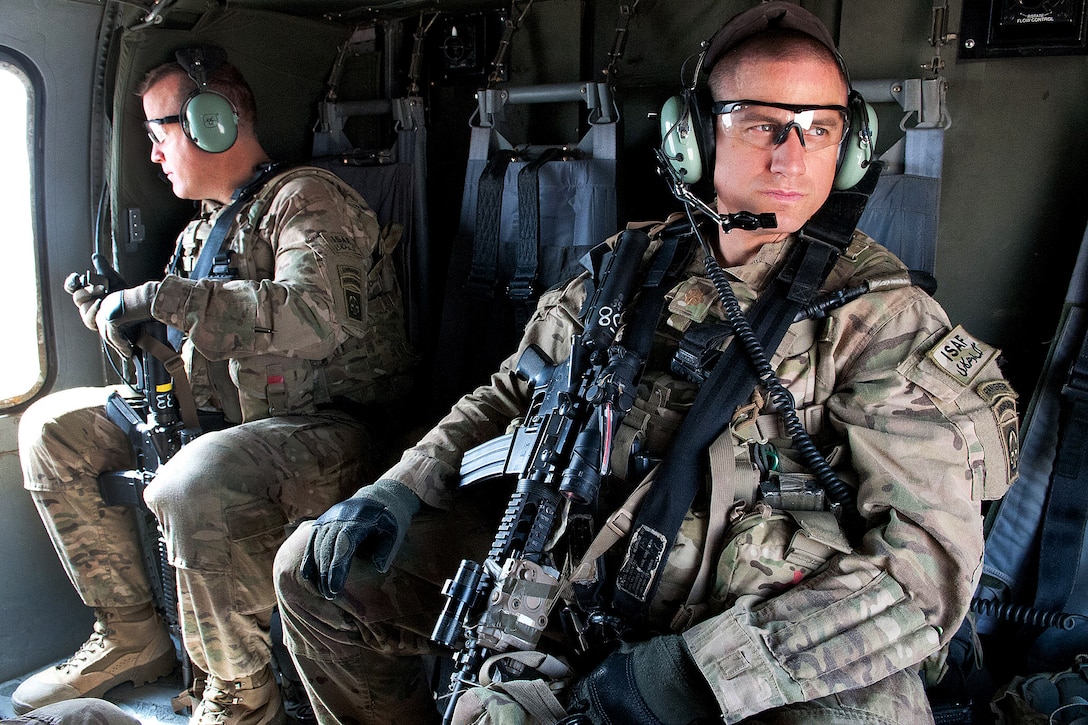 U.S. Maj. Mark Stouffer, right, and U.S. Army Col. Mark L. Stock participate on a battlefield circulation trip aboard a UH-60 Black Hawk helicopter in Afghanistan's Ghazni province, April 1, 2012. Stock is the commander of the 82nd Airborne Division’s 1st Brigade Combat Team, and Stouffer is the unit's operation's officer.