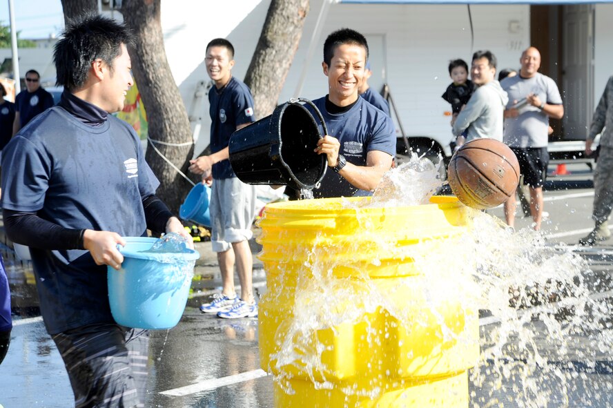 Firefighters from Towada City race against members of the 35th Civil Engineer Squadron Team B during the bucket brigade event part of the firefighter combat challenge relay competition, at Misawa Air Base, Japan, Oct. 7, 2012. Team B was the fastest team to knock out the ball with a time of one minute, nine seconds. (U.S. Air Force photo/Tech. Sgt. Marie Brown)