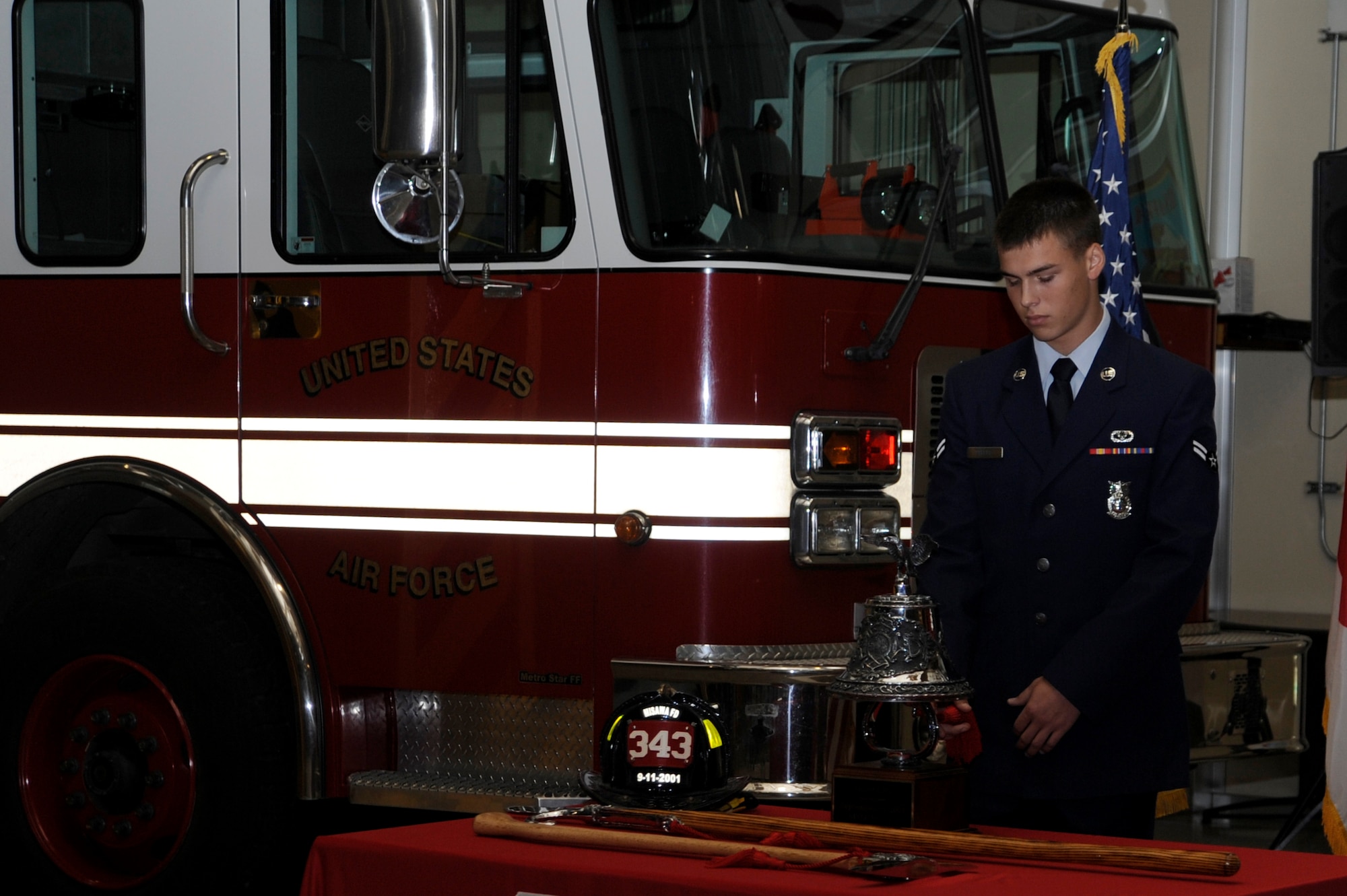 U.S. Air Force Airman 1st Class Justin Phelps, 35th Civil Engineer Squadron firefighter, sounds the last alarm during the Bells Across America Memorial Service, part of the National Fallen Firefighter Memorial Weekend, at Misawa Air Base, Japan, Oct. 7, 2012. Departments sound a series of bells when a firefighter dies in the line of duty to alert all members that a comrade had made the ultimate sacrifice. (U.S. Air Force photo/Tech. Sgt. Marie Brown)