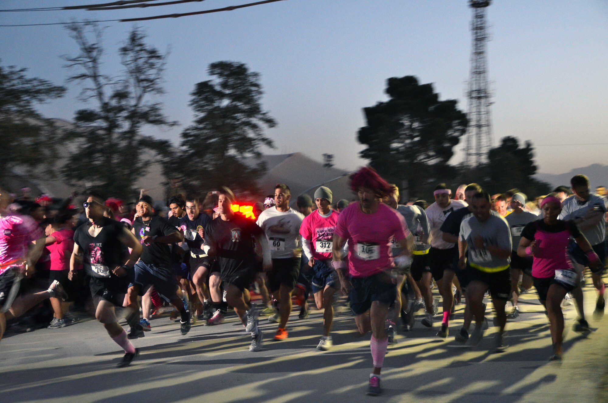 More than 700 U.S. Servicemembers and civilians begin the first leg of the 401st Army Field Support Brigade Breast Cancer Awareness 8K Walk/Run Relay at Bagram Airfield, Afghanistan, Oct. 6 2012. The race was a five-member team event, including at least one female per team. More than 700 participants registered in support of breast cancer awareness. Prizes were awarded to the first three teams to finish, and a best “pink costume” team prize. (U.S. Army photo/Summer Barkley/used by permission)