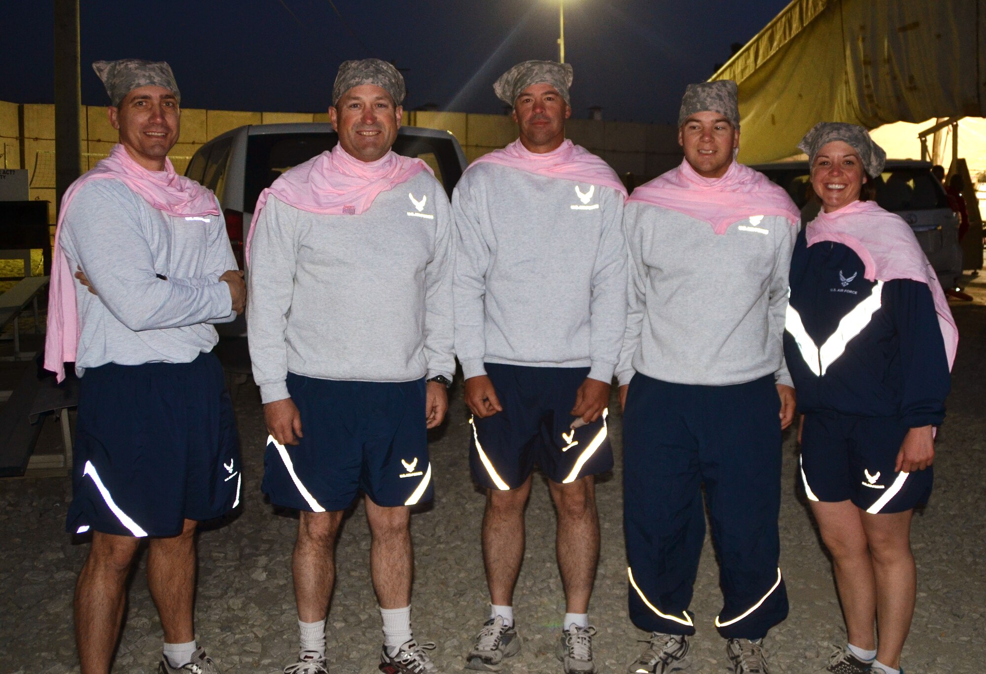 A group of Air Force Airmen pose for a photo after the 401st Army Field Support Brigade Breast Cancer Awareness 8K Walk/Run Relay at Bagram Airfield, Afghanistan, Oct. 6 2012. The race was a five-member team event, including at least one female per team. More than 700 participants registered in support of breast cancer awareness. Prizes were awarded to the first three teams to finish, and a best “pink costume” team prize. (U.S. Army photo/Summer Barkley/used by permission)