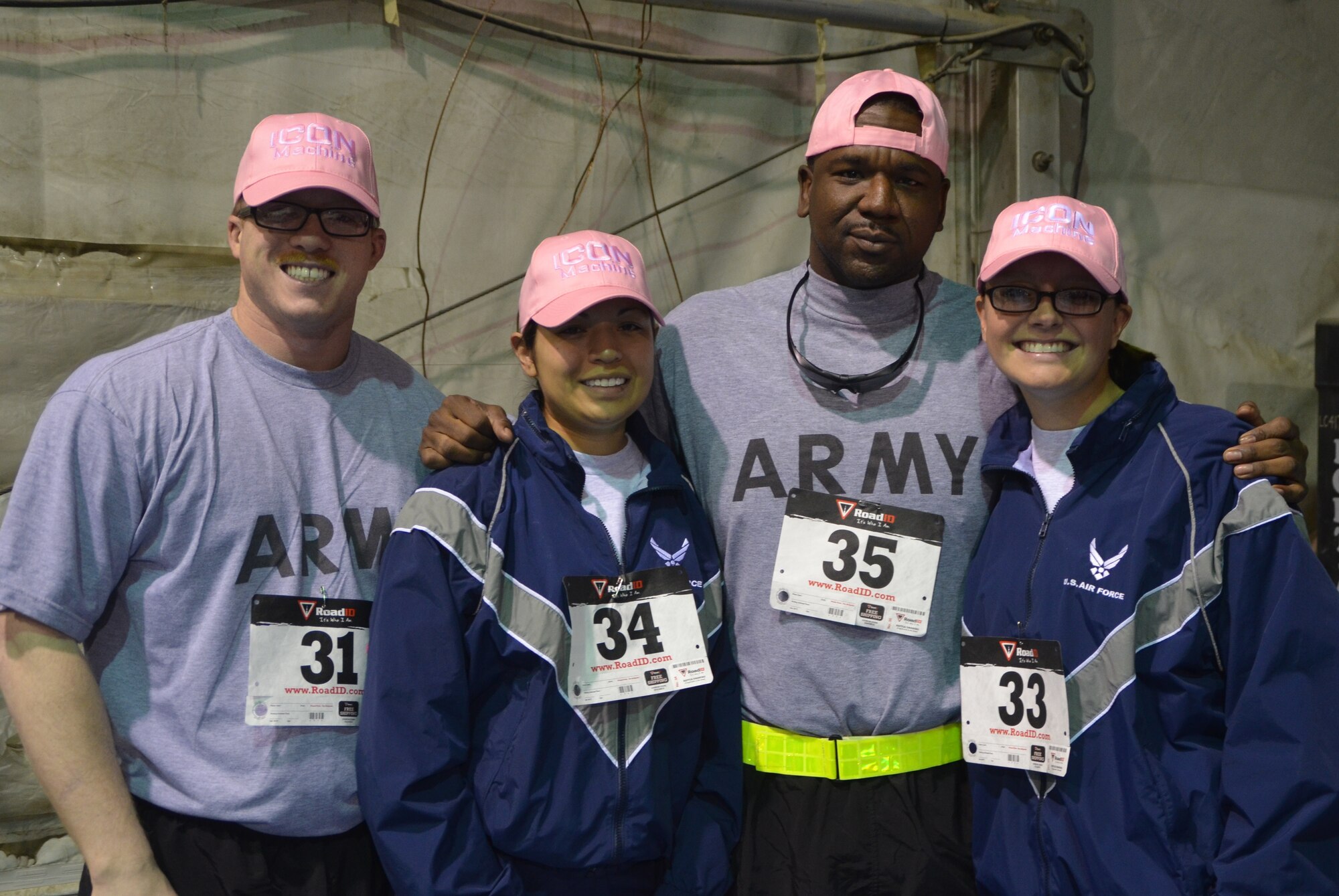 A group of Airmen and soldiers pose for a photo after the 401st Army Field Support Brigade Breast Cancer Awareness Walk/Run Relay at Bagram Airfield, Afghanistan, Oct. 6 2012. The race was a team event with five members including at least one female per team. More than 700 participants registered in support of breast cancer awareness. Prizes were awarded to the first three teams to finish, and a best “pink costume” team prize. (U.S. Army photo/Summer Barkley/used by permission)
