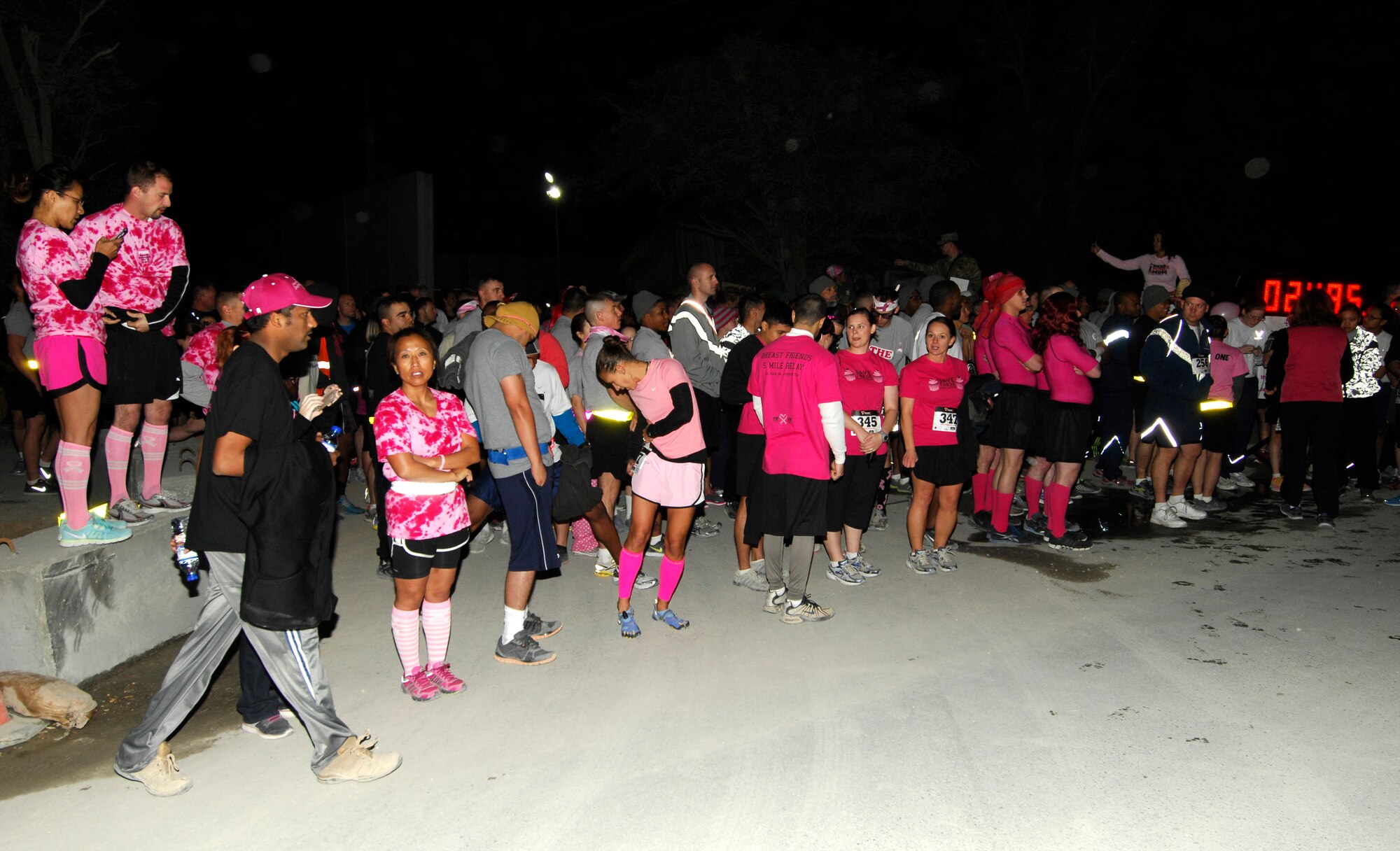 U.S. Servicemembers and civilians prepare to begin the 401st Army Field Support Brigade Breast Cancer Awareness 8K Walk/Run Relay at Bagram Airfield, Afghanistan, Oct. 6, 2012. The race was a five-member team event, including at least one female per team. More than 700 participants registered in support of breast cancer awareness. Prizes were awarded to the first three teams to finish, and a best “pink costume” team prize. (U.S. Air Force photo/SSgt Jeff Nevison)