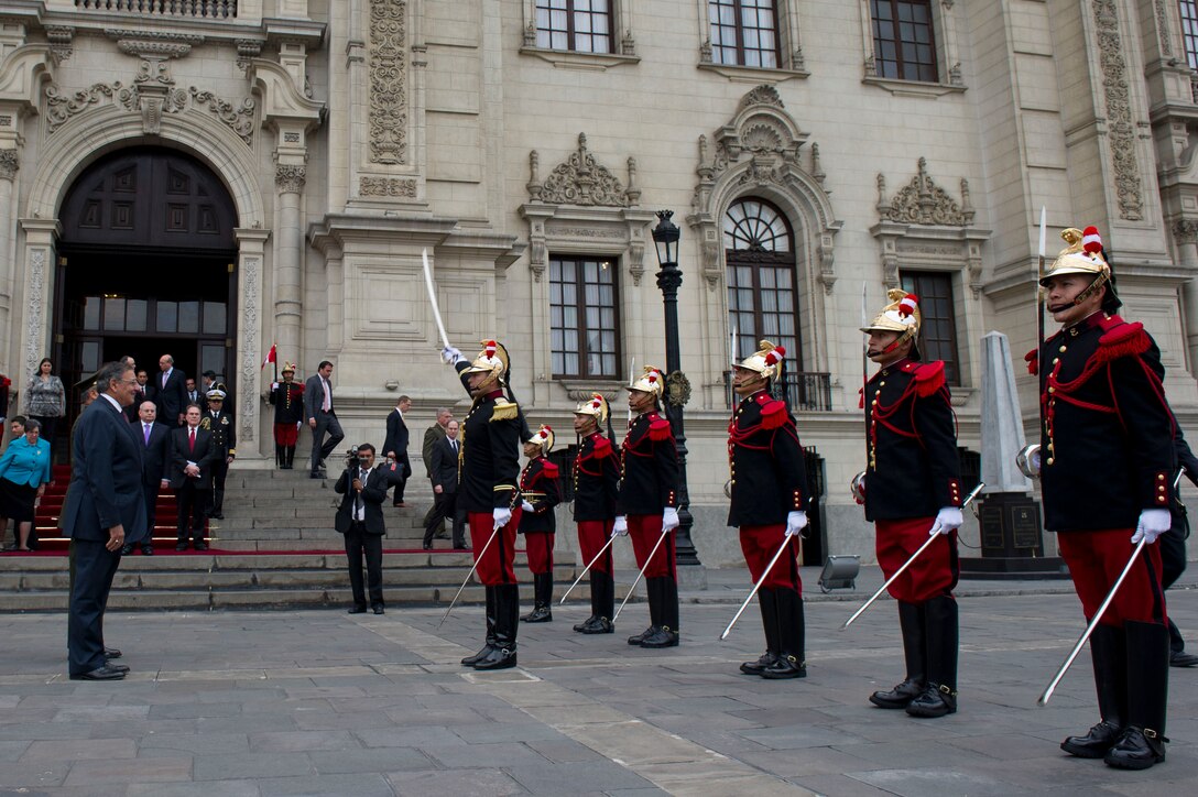 Peruvian soldiers in ceremonial dress uniforms salute U.S. Defense Secretary Leon E. Panetta upon his arrival at the presidential palace in Lima, Peru Oct. 6, 2012.