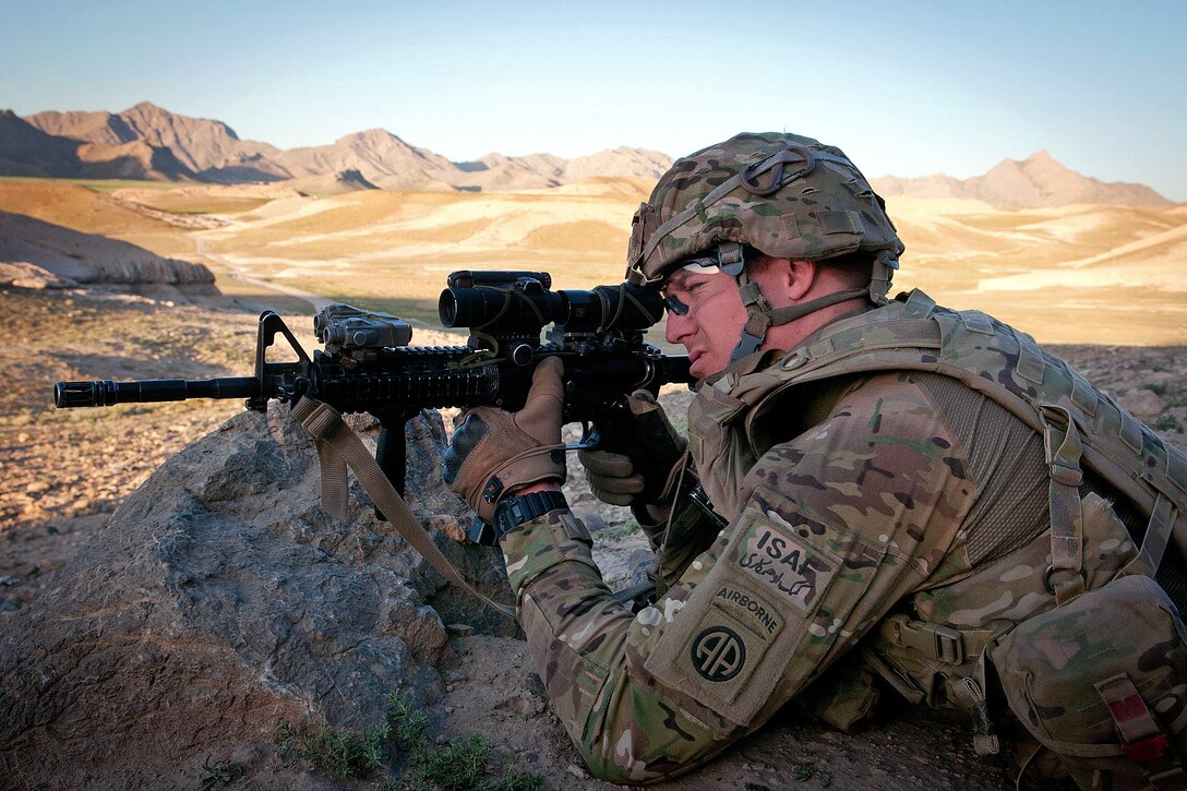 A U.S. paratrooper pulls security during a combat operation in Afghanistan's Ghazni province, June 2, 2012. The soldier is assigned to the 82nd Airborne Division’s 1st Brigade Combat Team. Helicopters delivered fellow paratroopers and Afghan soldiers into the rugged mountain terrain.