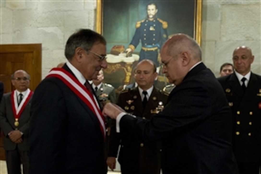 U.S. Defense Secretary Leon E. Panetta is presented with the Military Order of Ayacucho by Peruvian Defense Minister Pedro Cateriano Bellido during a ceremony in Lima, Peru Oct. 6, 2012. Panetta is visiting South America on a four-day trip to strenghten defense relationships with Western Hemisphere counterparts.