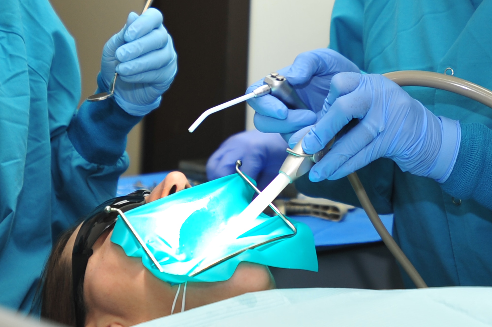A Red Cross dental volunteer demonstrates her learned skills  during a routine dental procedure at Osan Air Base, Republic of Korea, Oct. 4, 2012. The Red Cross Dental Certification Program reenacted at Osan and is currently training five military spouses as qualified technicians. (U.S. Air Force photo/Airman 1st Class Alexis Siekert)
