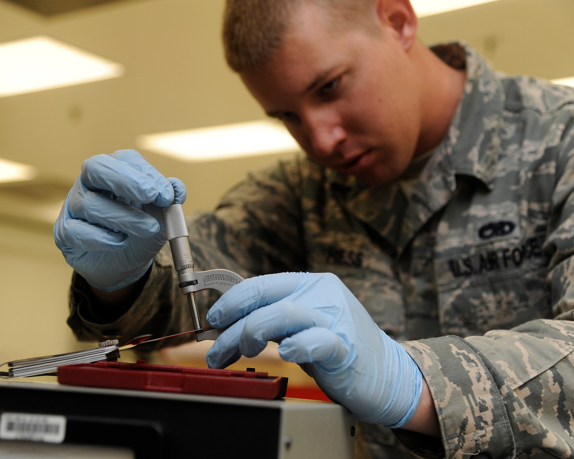 Senior Airman Mitchell Hess, 8th Maintenance Squadron precision measurement equipment laboratory technician, uses a micrometer to verify the thickness of a feeler gauge at Kunsan Air Base, Republic of Korea, Oct. 3, 2012. Having precisely calibrated equipment allows pilots to put bombs on targets accurately. (U.S. Air Force photo/Senior Airman Marcus Morris)