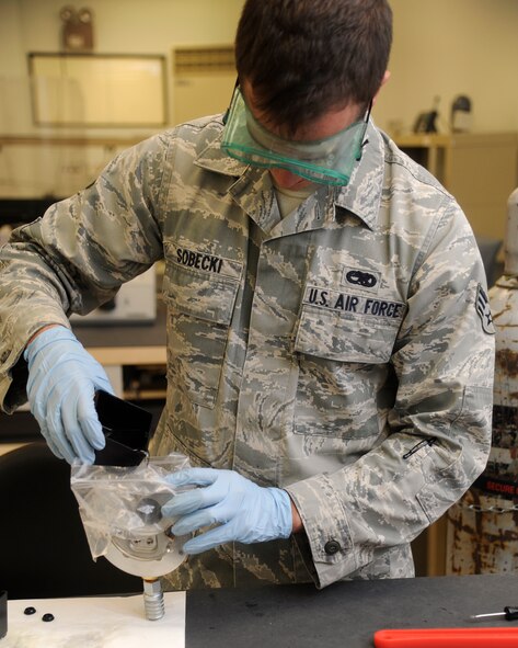 Senior Airman Michael Sobecki, 8th Maintenance Squadron, precision measurement equipment laboratory technician, pours glycerin into a hydraulic pressure gauge at Kunsan Air Base, Republic of Korea, Oct. 3, 2012. The glycerin is used to stabilize the gauge needle   and insures an accurate reading. (U.S. Air Force photo/Senior Airman Marcus Morris)