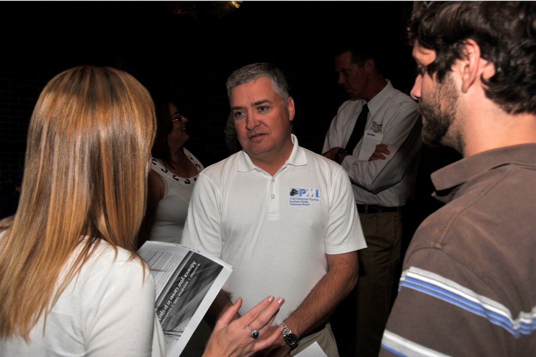 Jon Paul Wallace (center), an Aerospace Testing Alliance project manager, recently spoke with attendees of the American Institute of Aeronautics and Astronautics (AIAA) and the Arnold Association of Professional Societies (AAPS) membership encouragement social about the Project Management Institute (PMI). (Photo by Rick Goodfriend)