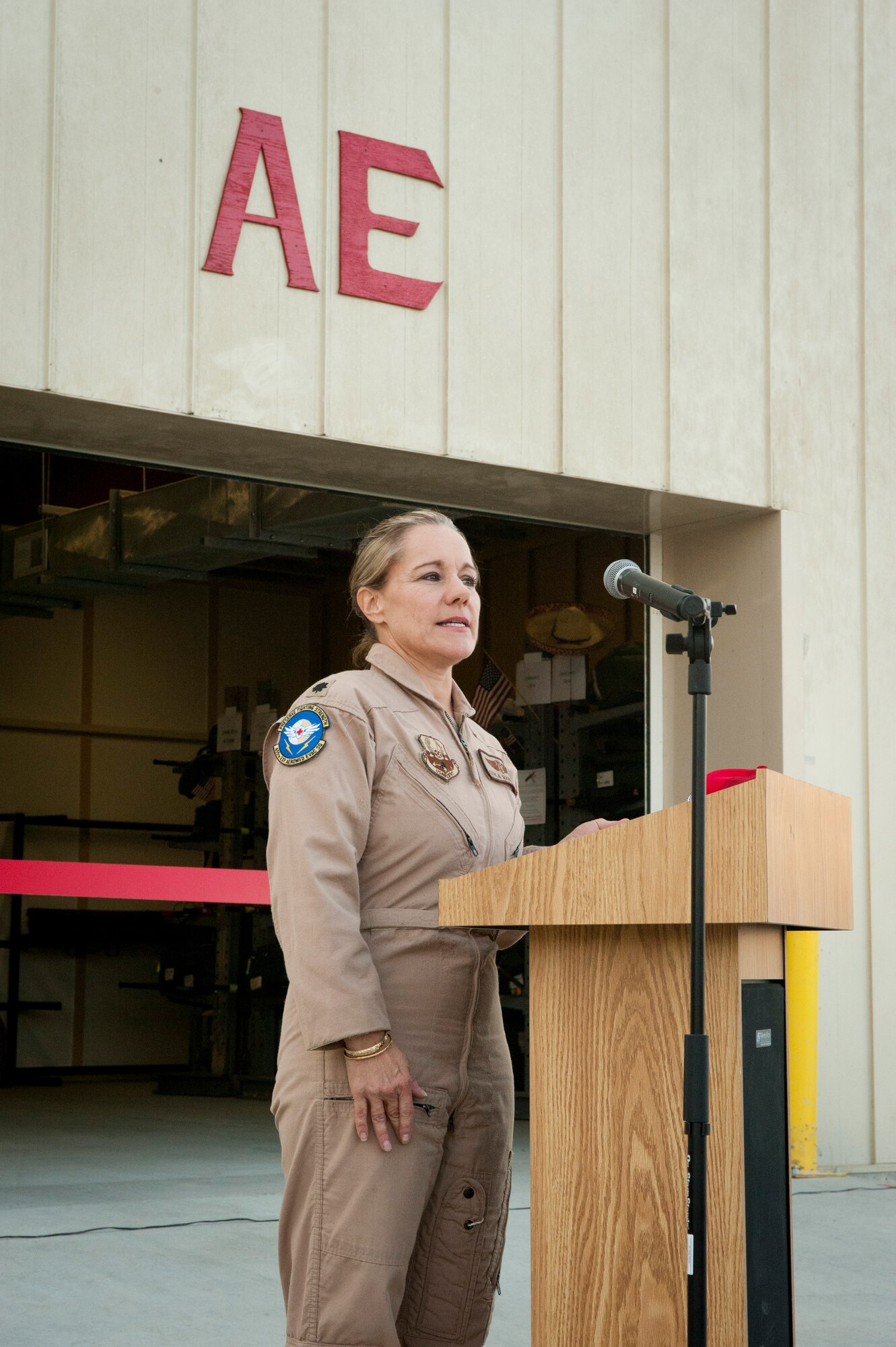 Lt. Col. Carla Marcinek, 455th Expeditionary Aeromedical Evacuation Squadron commander, gives remarks thanking the various units that helped build the new unit facility during the ribbon cutting ceremony of the new aeromedical evacuation facility. The new facility will enable medical technicians and flight nurses to respond faster and work more efficiently when providing medical care to wounded servicemembers. (U.S. Air Force photo/SSgt Neal Uranga)