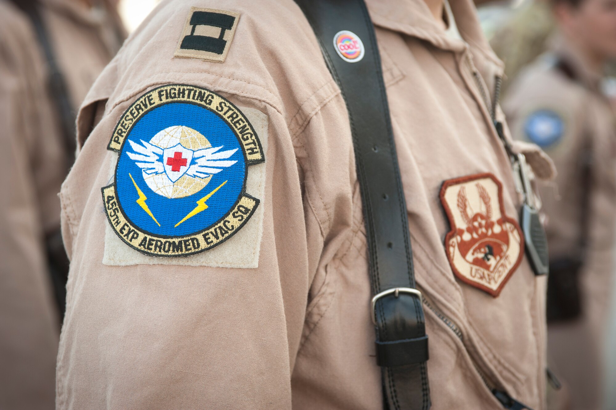 A U.S. Air Force Captain with the 455th Expeditionary Aeromedical Evacuation Squadron stands in formation during the ribbon ceremony of the new 455 EAES facility. The new facility will enable medical technicians and flight nurses to respond faster and work more efficiently when providing medical care to wounded servicemembers. (U.S. Air Force photo/SSgt Neal Uranga)