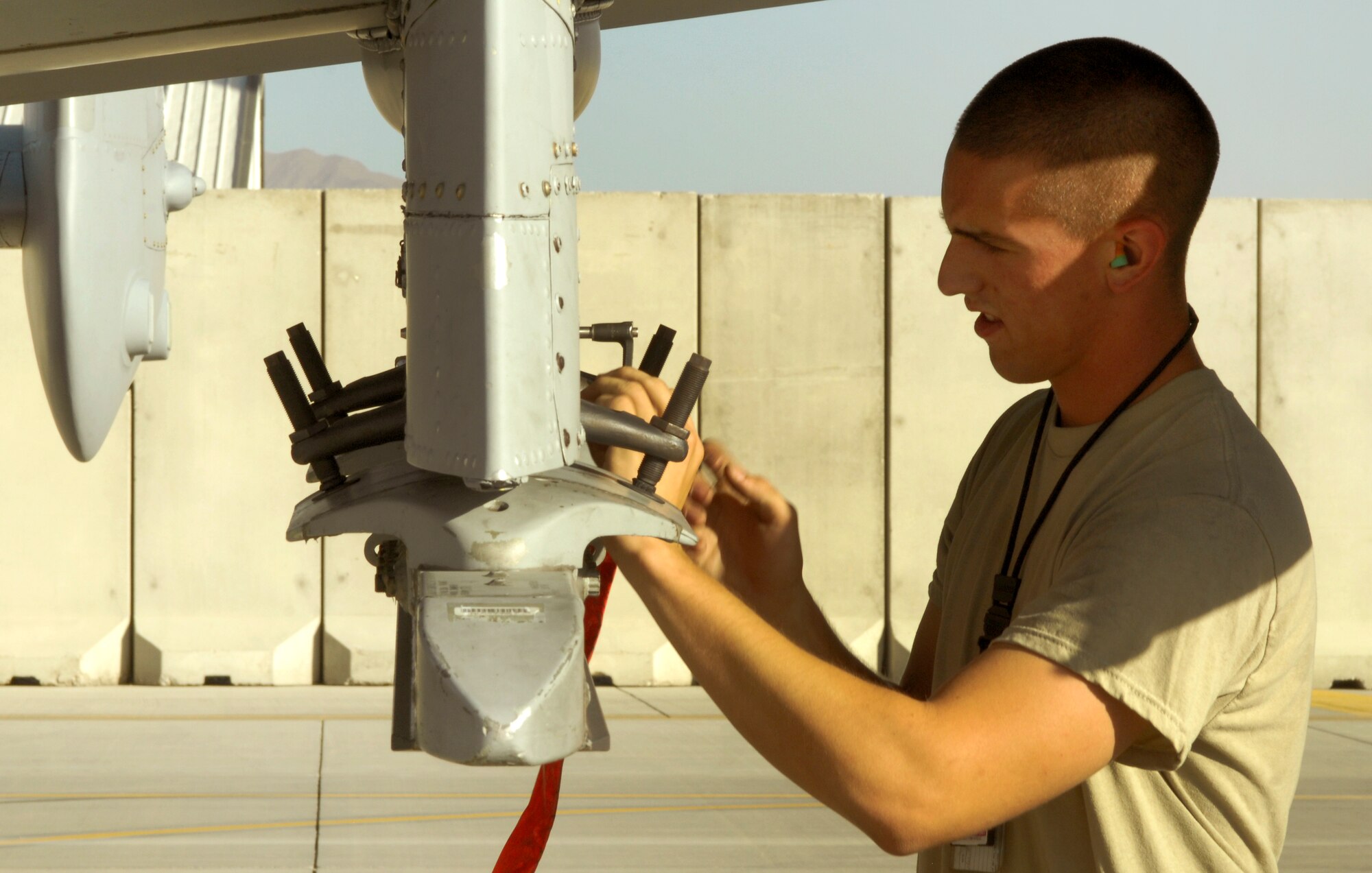 A weapons loader from the 455th Expeditionary Aircraft Maintenance Squadron prepares to arm a newly arrived A-10 Thunderbolt II from Davis-Monthan Air Force Base’s 354th Fighter Squadron at Bagram Airfield, Afghanistan, Oct. 4, 2012. Davis-Monthan pilots and maintainers are among the newest members of the 455th Air Expeditionary Wing. (U.S. Air Force photo/Staff Sgt. Jeff Nevison)