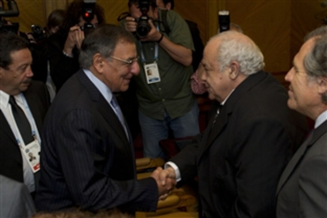 Secretary of Defense Leon E. Panetta, left, shakes hands with Urugayan Defense Minister Eleuterio Fernandez Huidobro before a meeting during a conference for defense ministers in Punta del Este, Uruguay, Oct 7, 2012. Panetta is visiting South America to strengthen defense partnerships with countries in the region.
